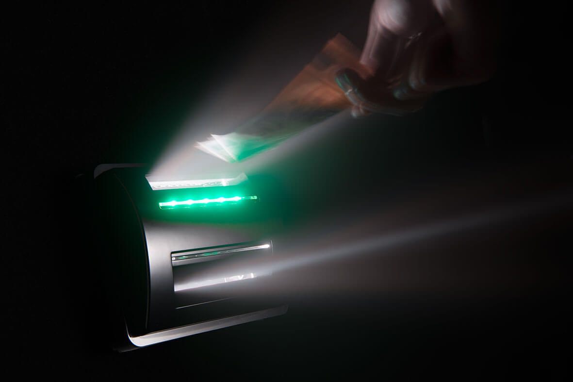 Banknote acceptor in action, ensuring counterfeit money protection and enhancing security in financial transactions.